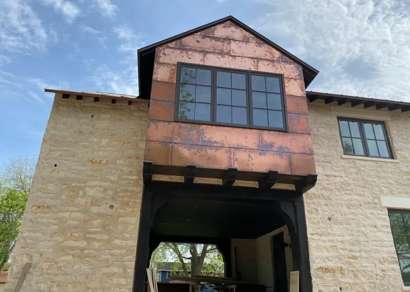 Copper metal panel facade on a stone building for Skylight Installation in South Lakes