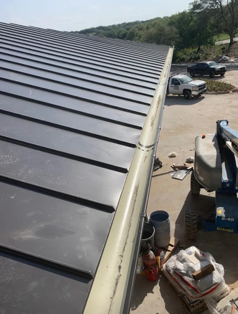 Standing seam panel and gutter detail on a metal roofing jobsite in South Lakes